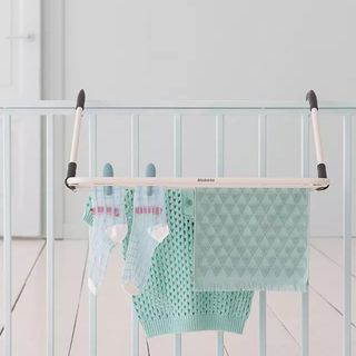 Removable white drying rack attached to cot