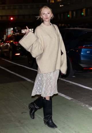 Alex Consani wears a lace skirt.