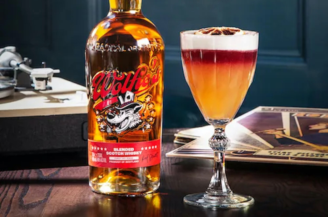 A cocktail and a bottle of whisky