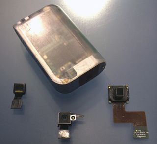 Second-generation handheld scanner with current generation sensor (left), iPhone 4 camera - for size comparison (middle), and first generation sensor (right)
