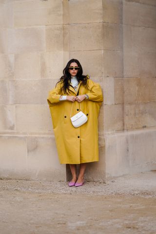 woman wearing yellow poncho rain coat and heels