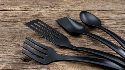 black plastic kitchen tools on wooden counter