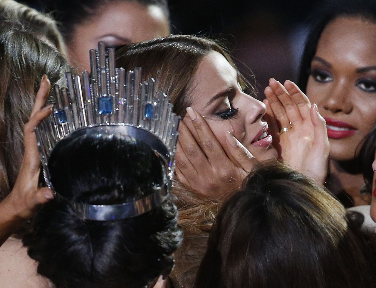 Other contestants comfort Miss Colombia Ariadna Gutierrez, center right, after she was incorrectly crowned Miss Universe at the Miss Universe pageant.