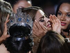Other contestants comfort Miss Colombia Ariadna Gutierrez, center right, after she was incorrectly crowned Miss Universe at the Miss Universe pageant.
