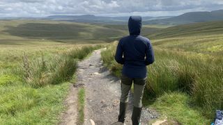 Julia Clarke from the back hiking in the Yorkshire Dales wearing the Montane Fireball Lite Hoodie