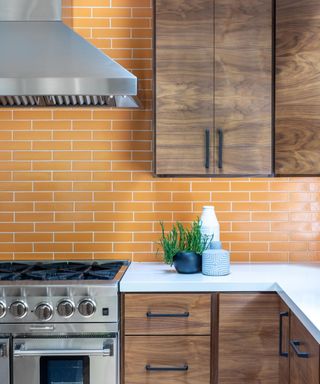 kitchen with wooden cabinets and orange tiles