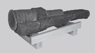 We see a digital image of a cannon on top of a wooden gun carriage.
