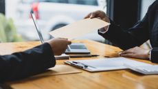 an attorney hands a document to a client