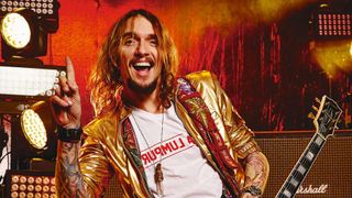 Justin Hawkins posing with a guitar