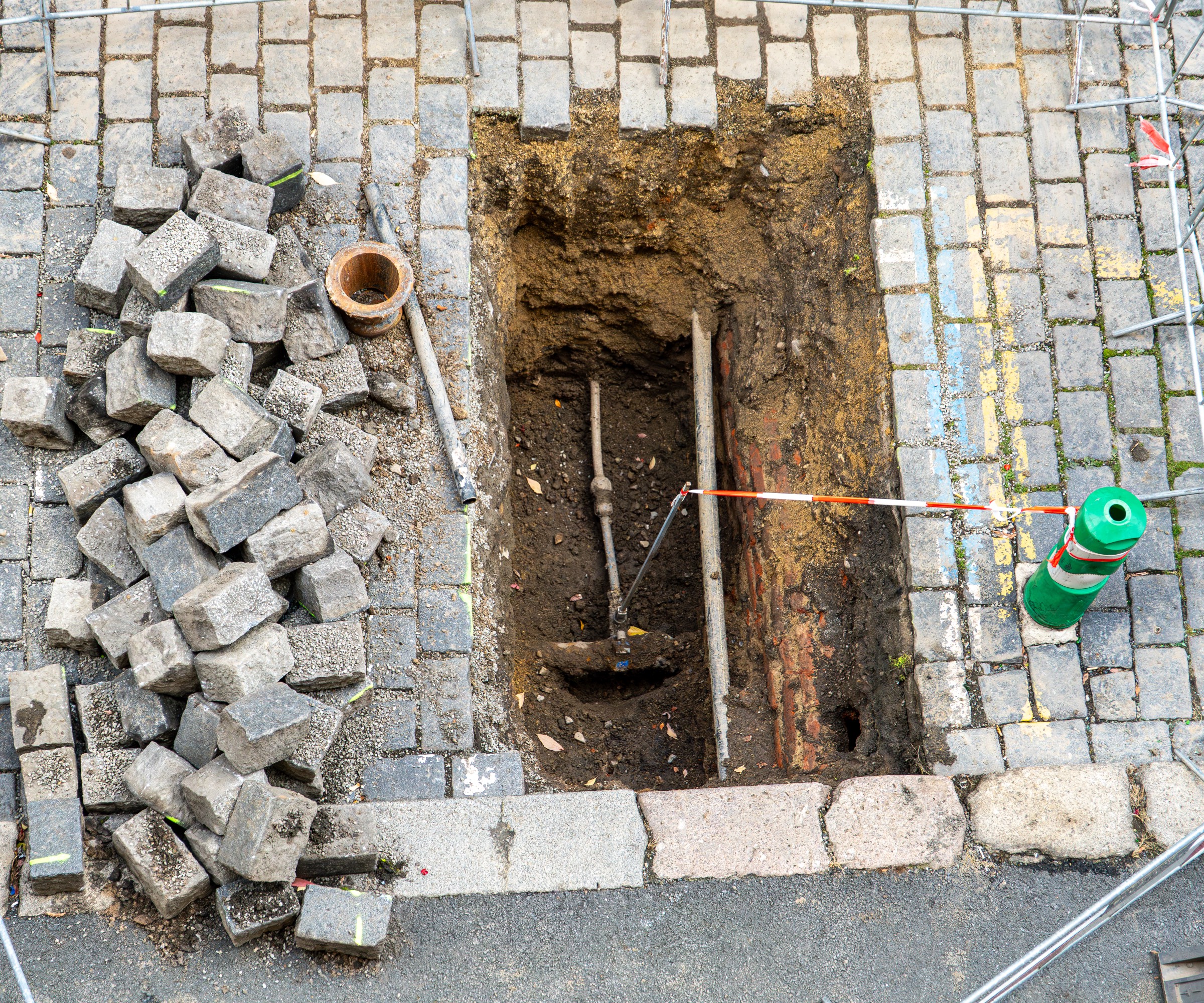 Utility workers performing excavation for street water line repair and maintenance