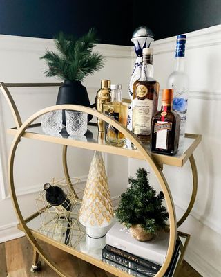 Gold bar cart with bottles of wine
