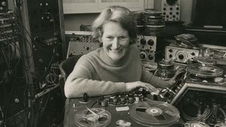 Image of Daphne Oram leaning on recording equipment in 1972