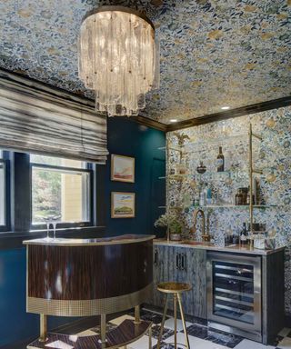 Home bar with decorative wallpaper on wall and ceiling, checkerboard tiled flooring, and teal painted wall