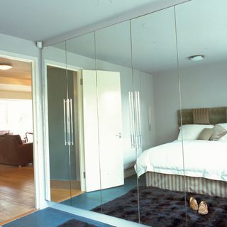 room with large wall mirrors and wooden flooring