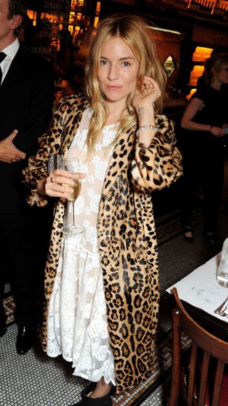 Sienna Miller wearing white lace maxi dress and long leopard print coat in 2013