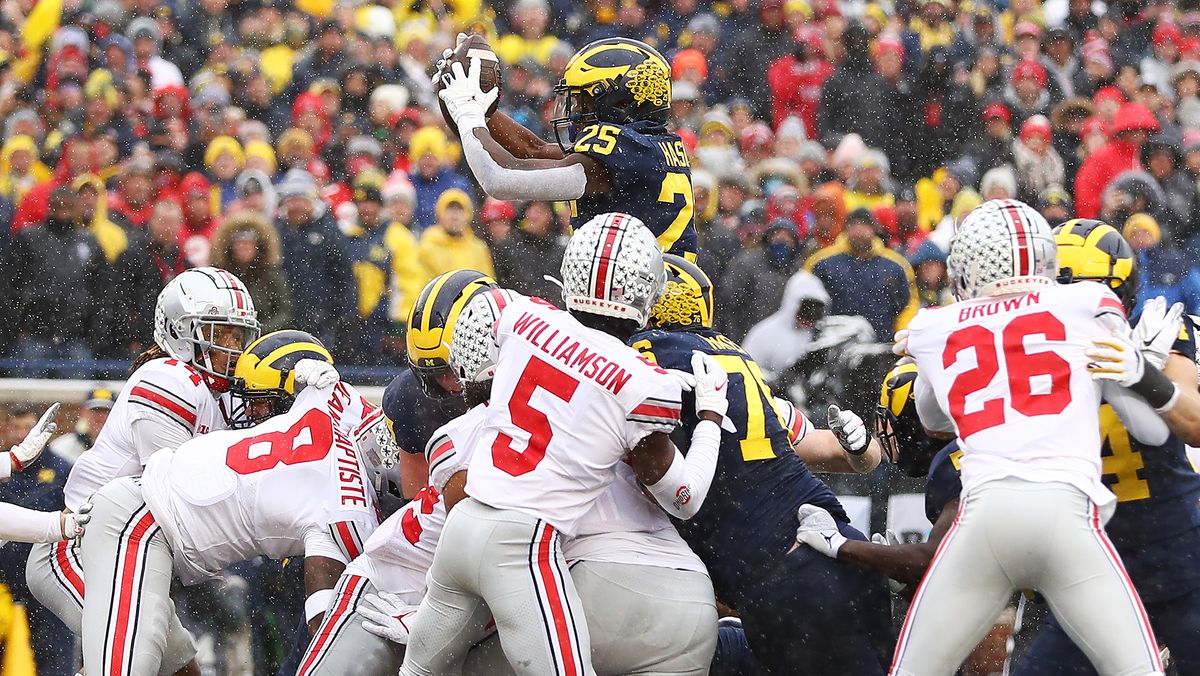 Hassan Haskins #25 of the Michigan Wolverines jumps into the end zone for a touchdown against the Ohio State Buckeyes during the second quarter at Michigan Stadium on Nov. 27, 2021 in Ann Arbor, Michigan.