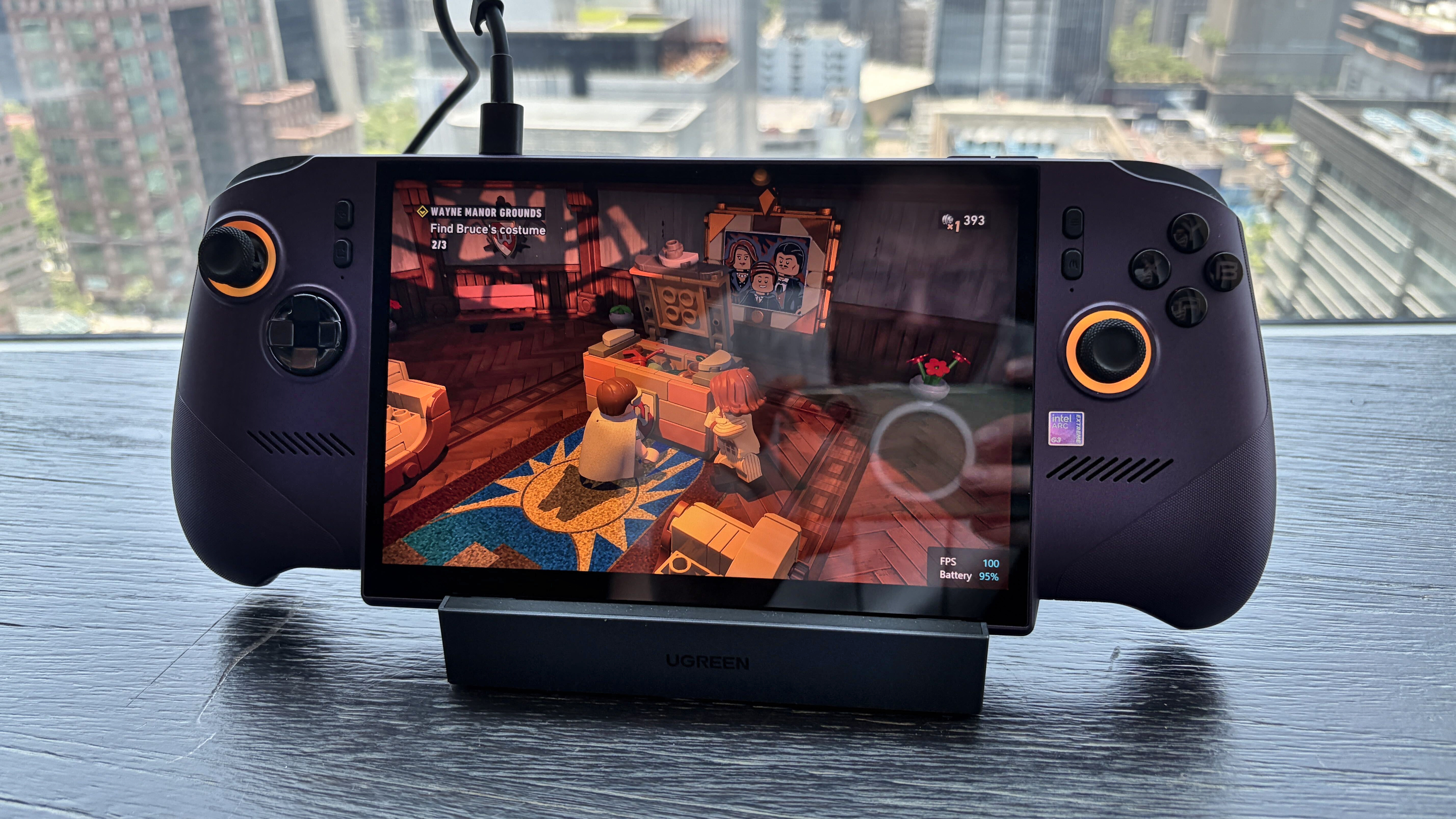 MSI Claw 8 EX AI+ handheld gaming console on a stand showing a LEGO video game scene.
