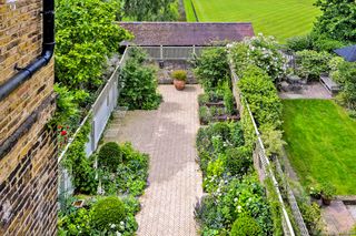 garden with borders and patio in house sold by savills