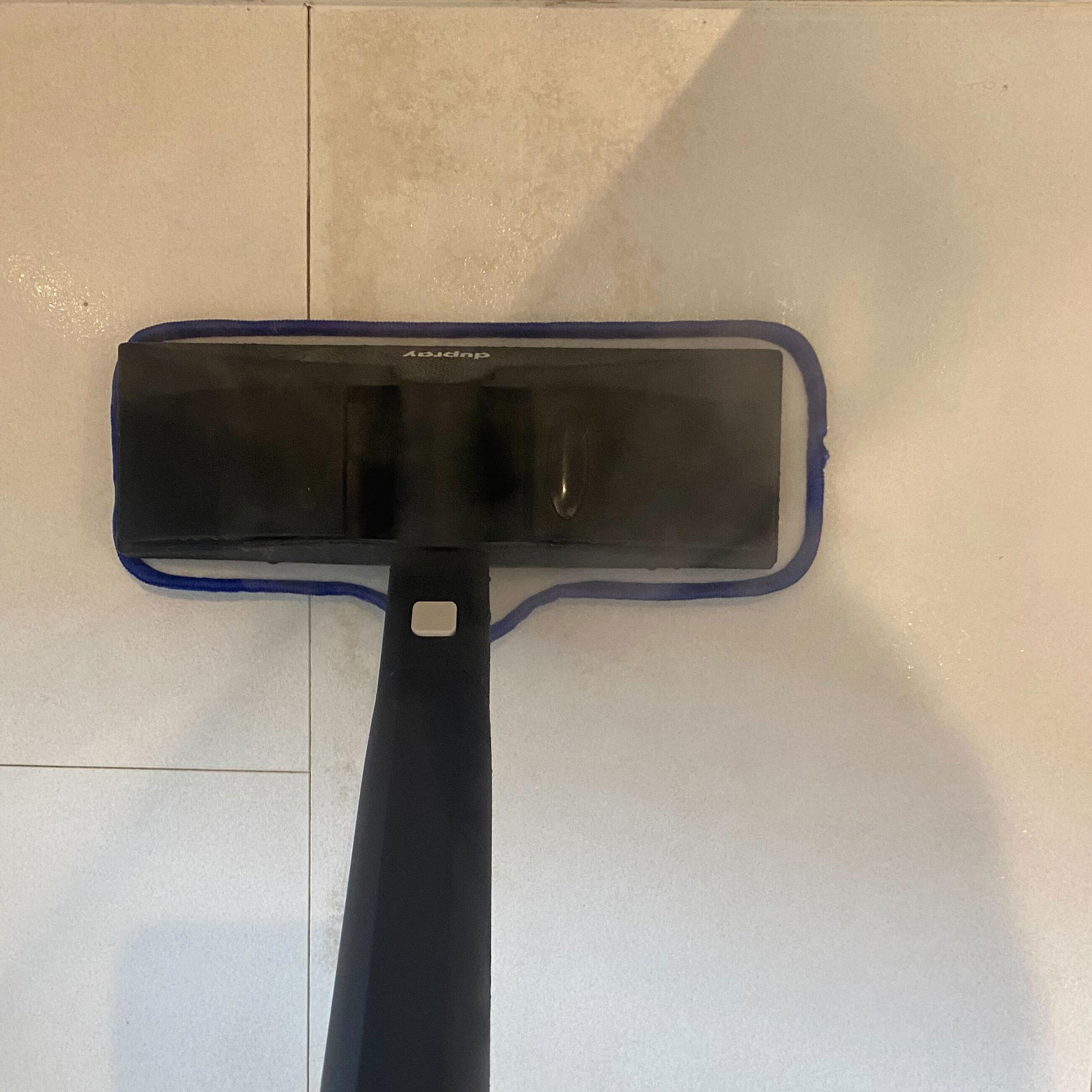 using the Dupray neat steam cleaner on bathroom floor stain