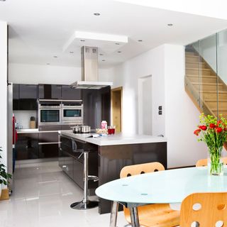 kitchen with black glossy cabinet and white wall with marble worktop