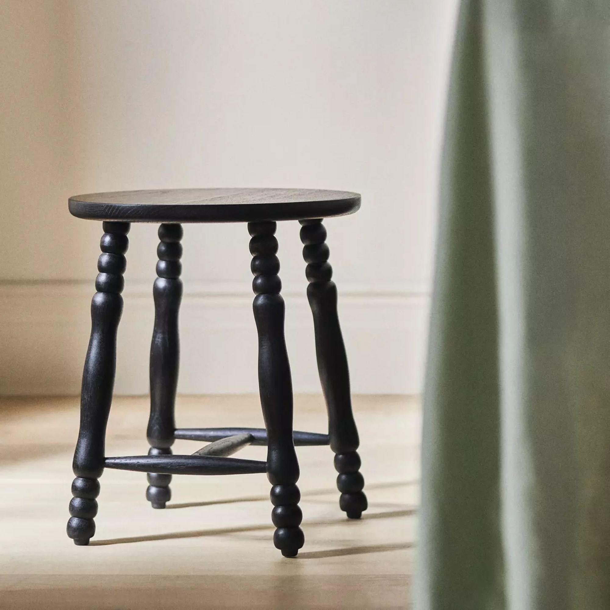 Low black wooden stool