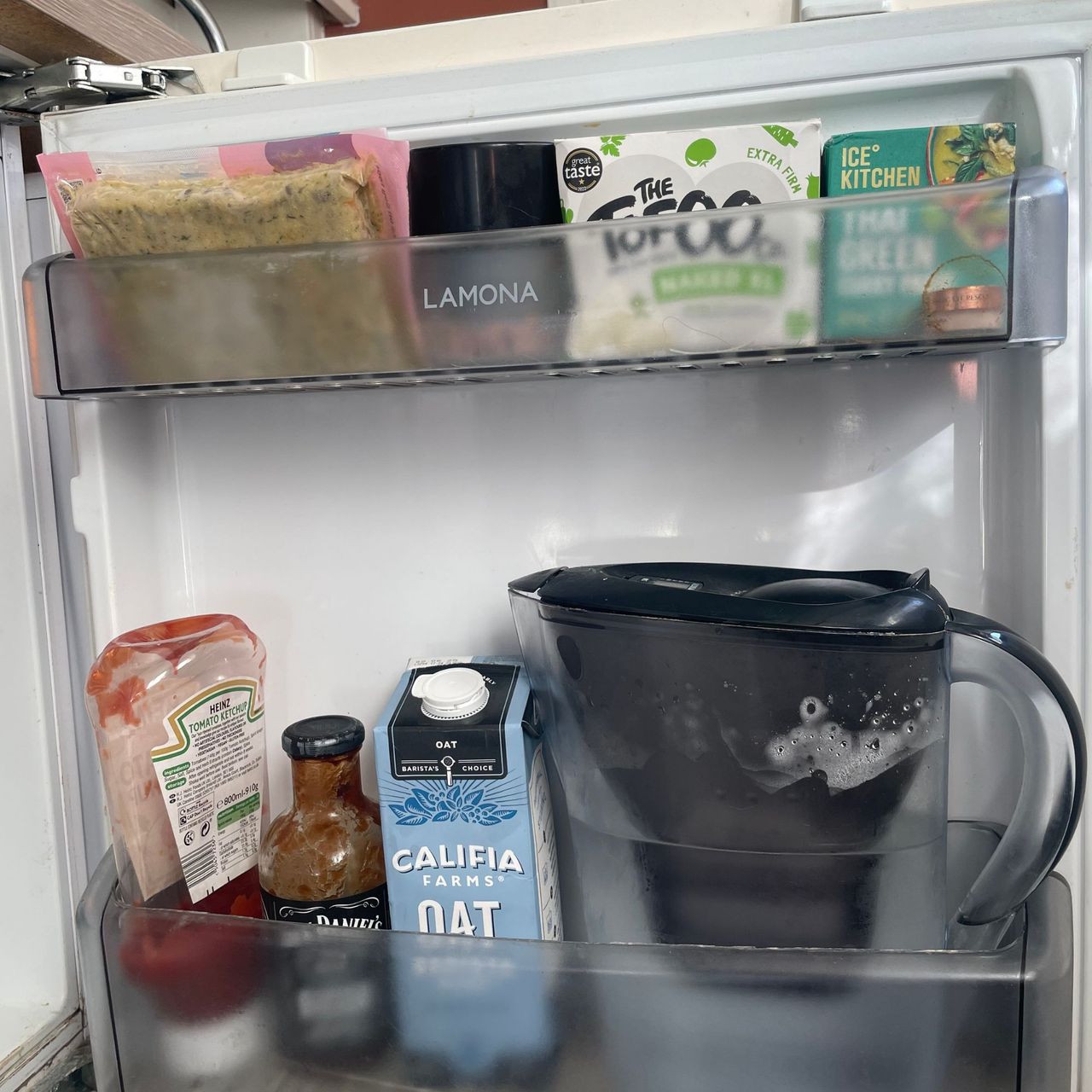Fridge door with food on shelves