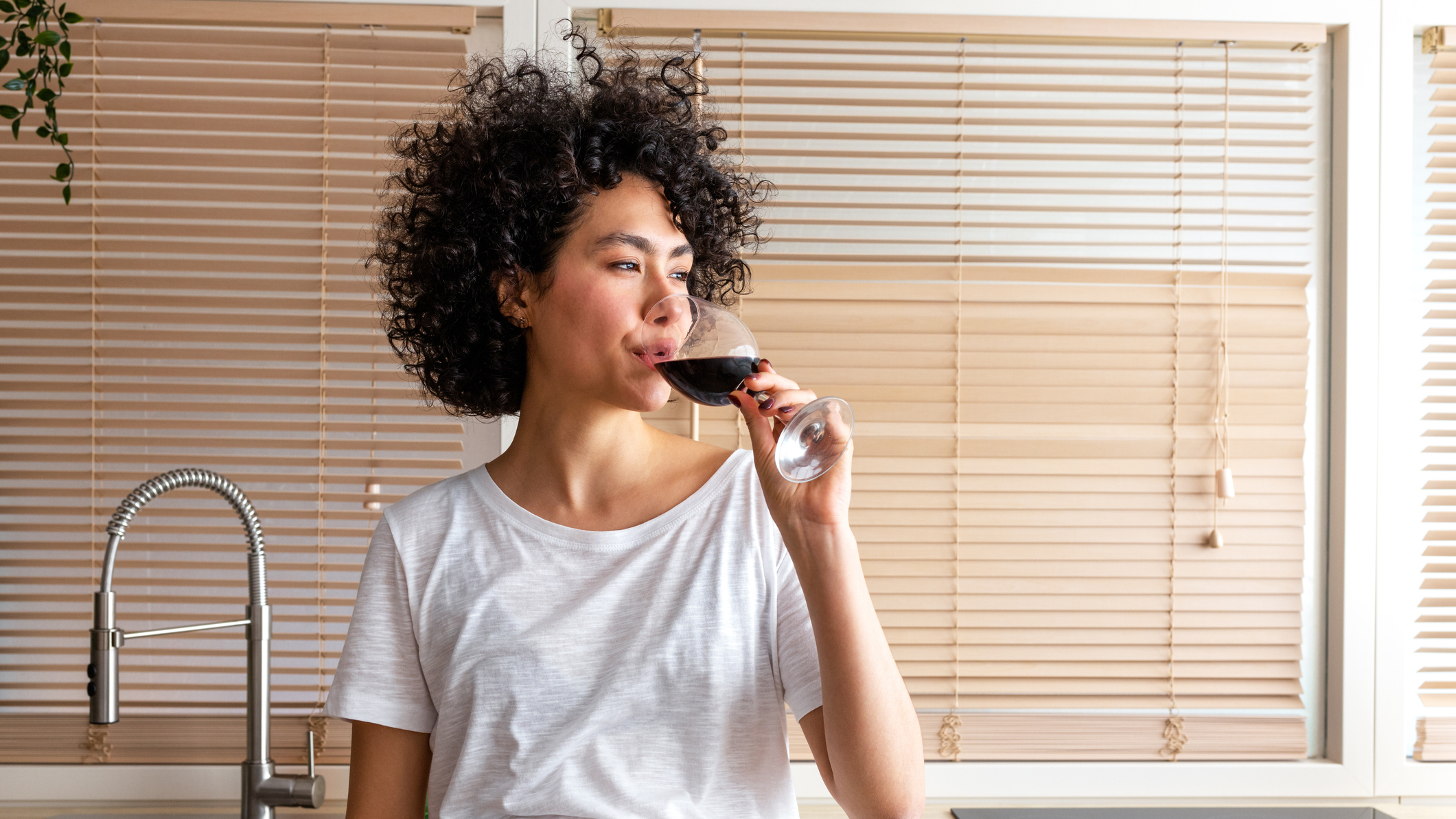 Woman drinking a glass of red wine