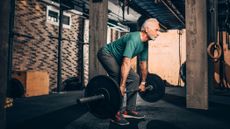 Man deadlifting with barbells