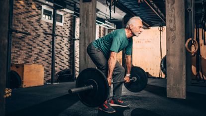 Man deadlifting with barbells