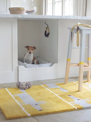 Dog bed in laundry room with yellow rug