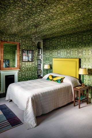 a bedroom with wallpapered walls and ceiling