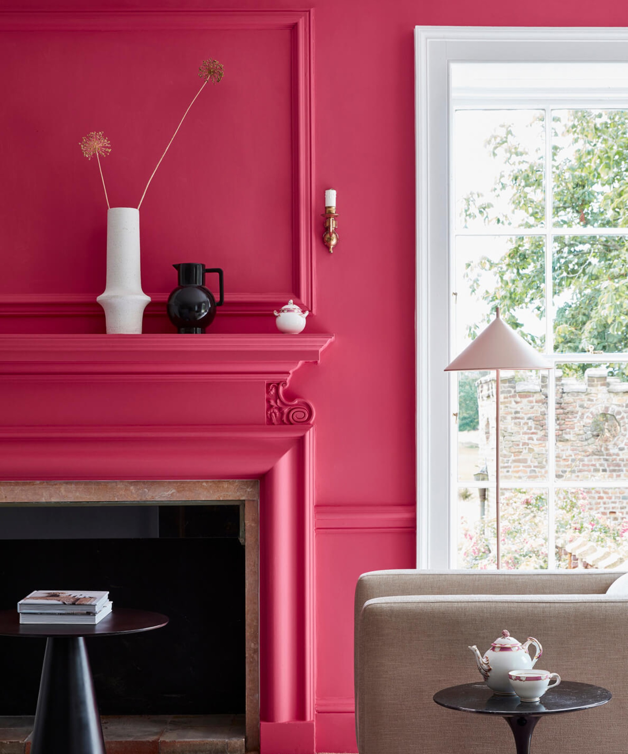 A living room painted in Little Greene's Leather bright pink shade