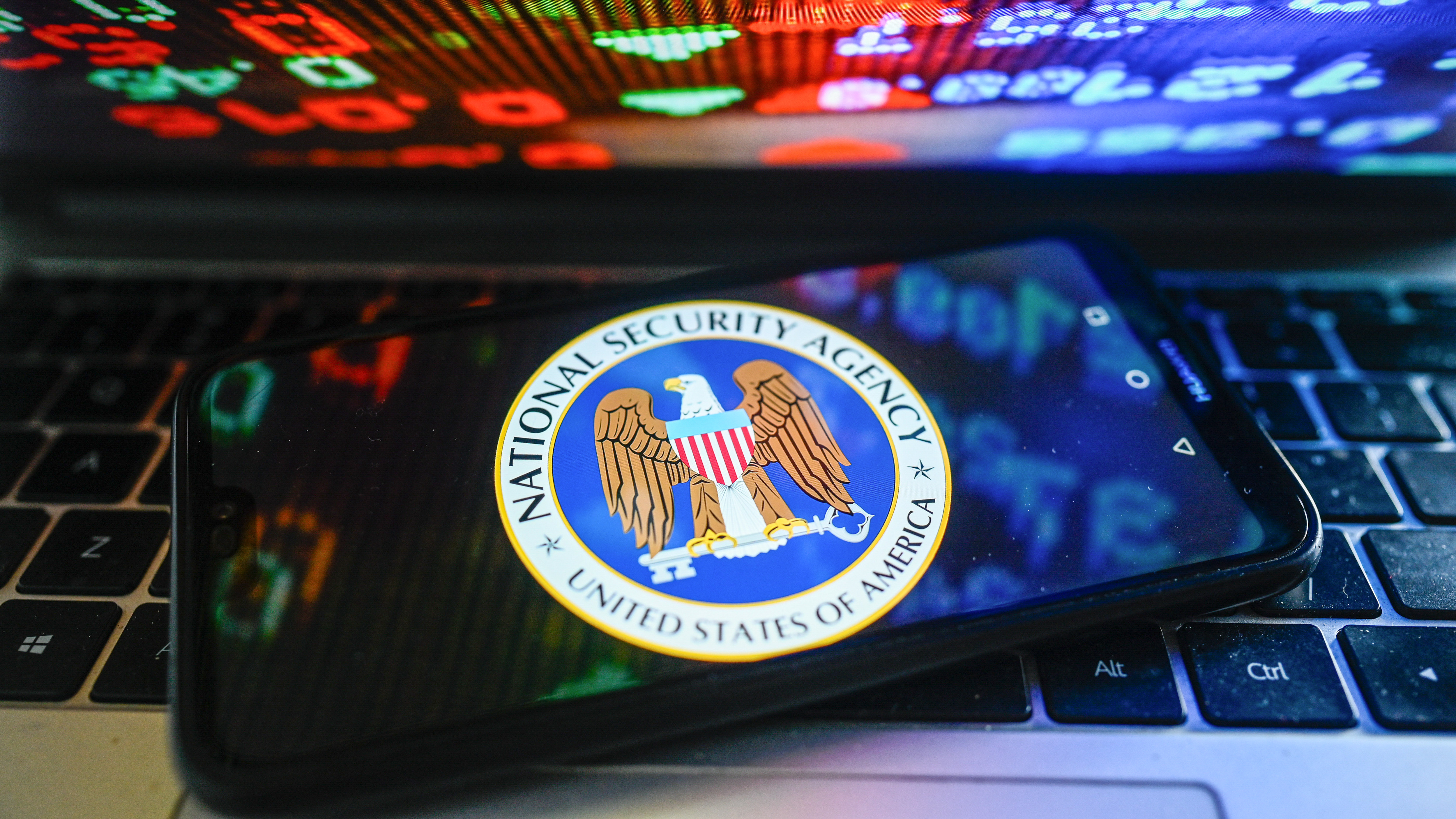 NSA logo on a cellphone sitting on a laptop