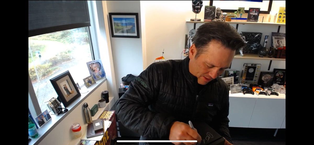 Phil Spencer signing the console.