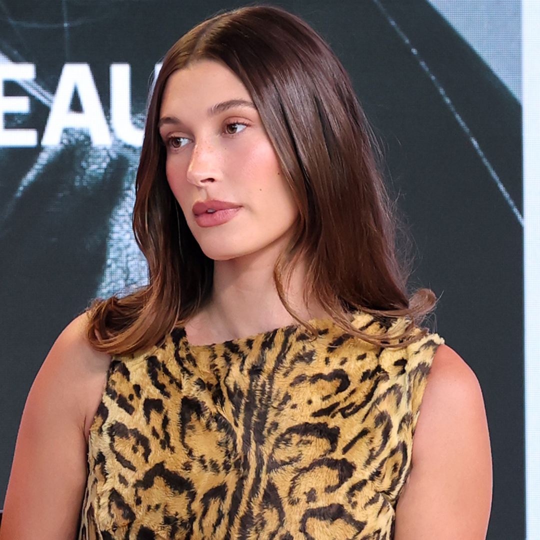 Hailey Bieber attends the Business of Beauty Global Forum in a vintage Versace leopard print dress.