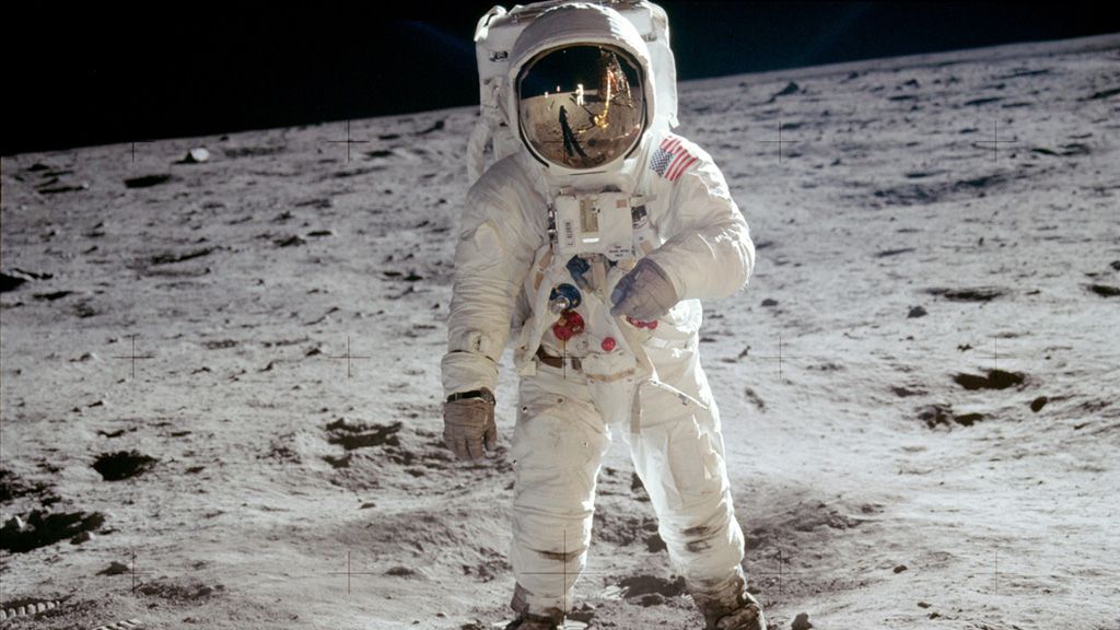 Buzz Aldrin, and Neil Armstrong reflected in his helmet, during the moon landing in 1969.