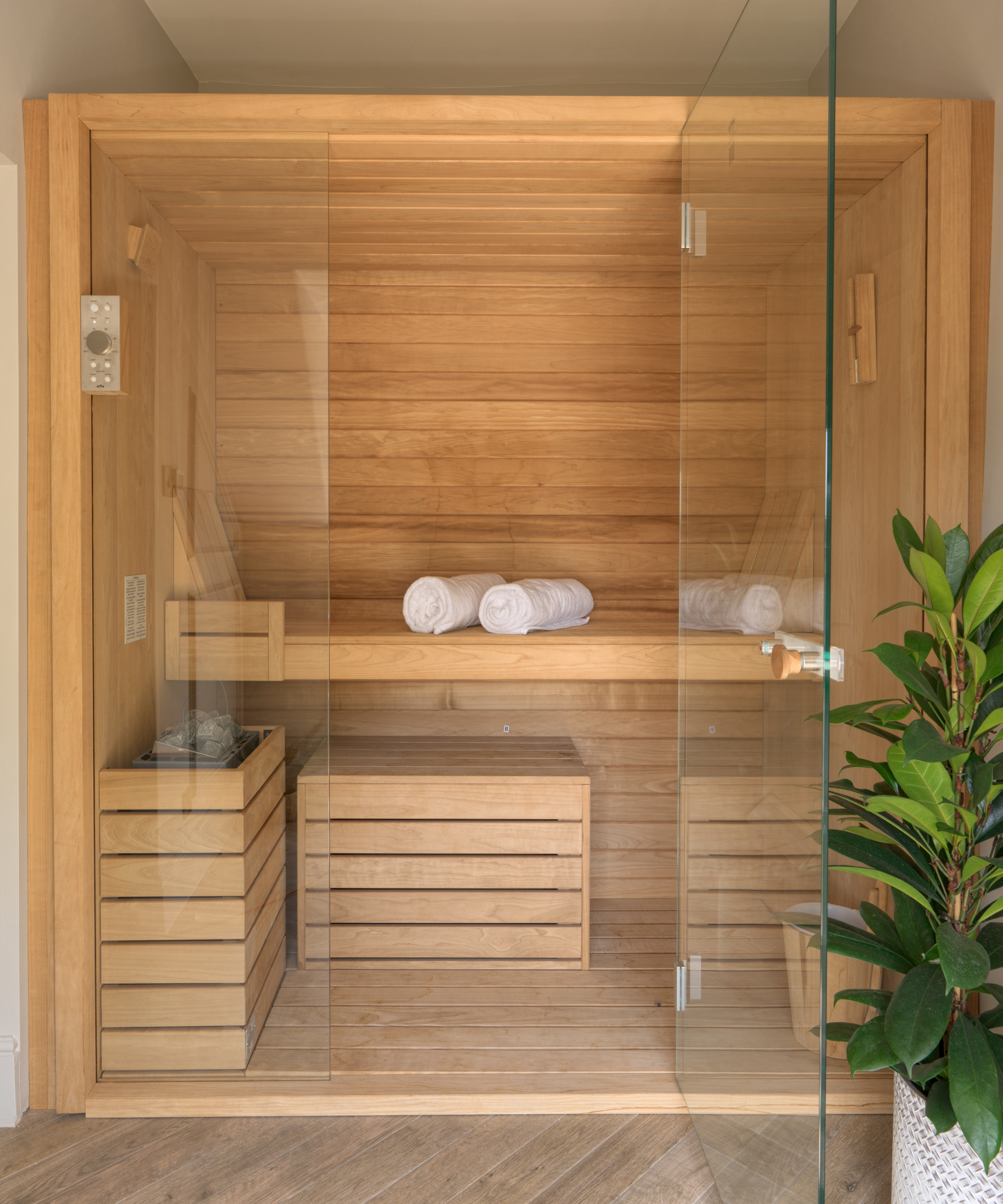 wooden sauna with glass doors inside home