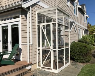 A white painted catio frame outside a house