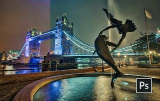 Dolphin statue in fountain with Tower Bridge in background