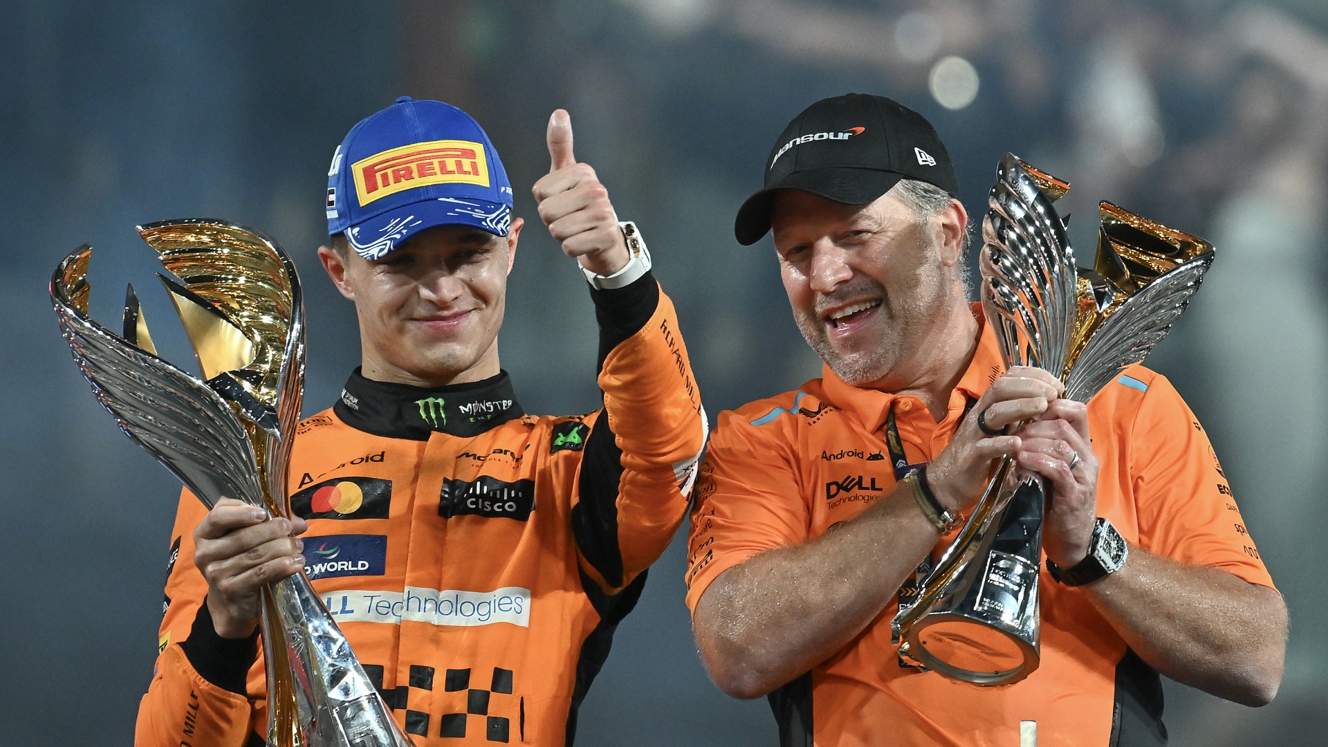 McLaren driver Lando Norris and Zak Brown celebrate on the podium of the Abu Dhabi Grand Prix in 2024