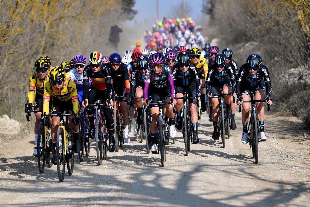 SIENA ITALY MARCH 05 LR Linda Riedmann of Germany and Team Jumbo Visma Lotte Kopecky of Belgium and Team SD Worx Marta Jaskulska of Poland and Team Liv Racing Xstra Floortje Mackaij of Netherlands and Team DSM and the peloton through gravel roads during the Eroica 8th Strade Bianche 2022 Womens Elite a 136km one day race from Siena to Siena Piazza del Campo 321m StradeBianche on March 05 2022 in Siena Italy Photo by Luc ClaessenGetty Images