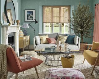 Mediterranean style living room with fireplace, olive tree and natural home accessories and furnishingsby John Lewis & Partners