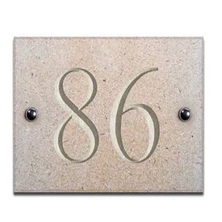 Sandstone house number with 86 on it.