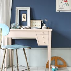 table with chair and indigo blue wall