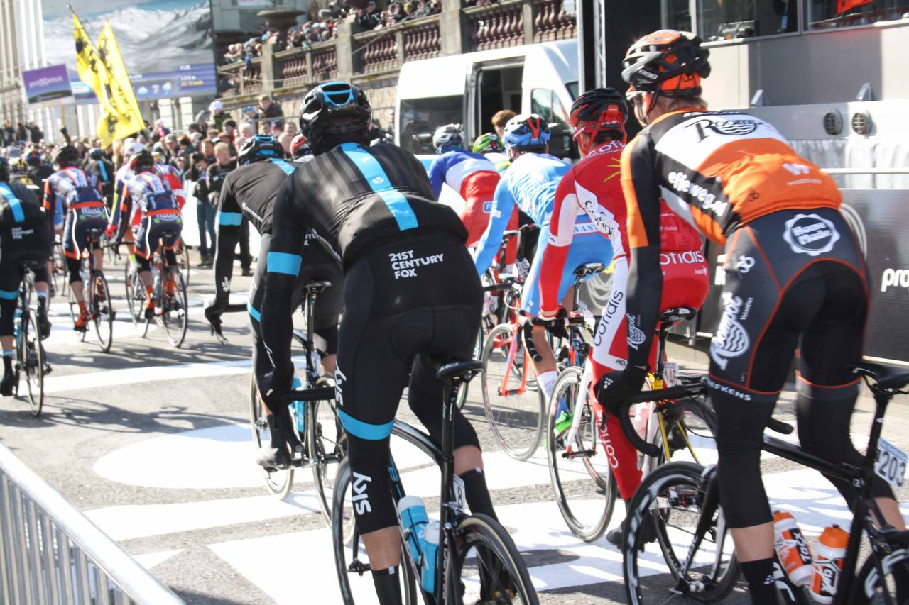 Bradley Wiggins and the Omloop Het Nieuwsblad peloton set out from Ghent.