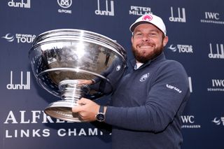 Tyrrell Hatton holds up the Alfred Dunhill Links Championship trophy after his win in 2024