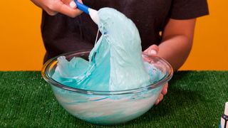 Keeping mixing your slime and adding contact lens solution until you get the consistency you like. Feel free to use your hands!