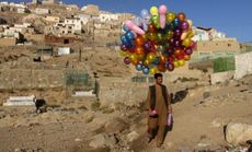 An Afghan man wanders through Kabul trying to sell his balloons, on Oct. 17, 2011.