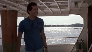 Steve Guttenberg smiling on a boat on the water in Cocoon.