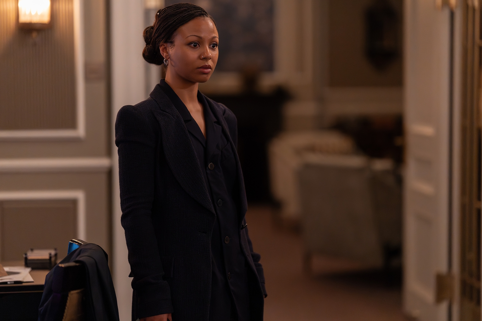 myha'la as harper wearing a black tailored suit in the hotel room office of her company in industry season 4
